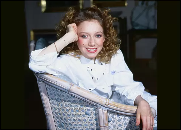 Lena Zavaroni sitting in whicker chair, wearing a white jump suit, aged 22. December 1985