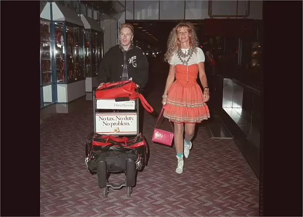 John Lydon singer of Public Image and wife Nora at London Airport, May 1990
