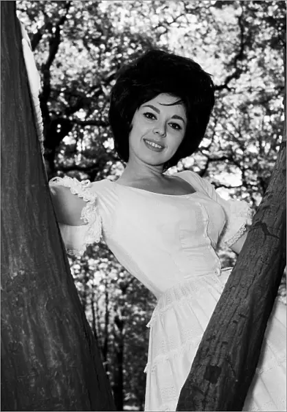 Actress and singer Susan Maughan, aged 20, photographed in a park near her home in