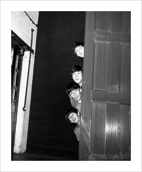 The Beatles peering out from behind a door before the groups appearence at Sunday Night