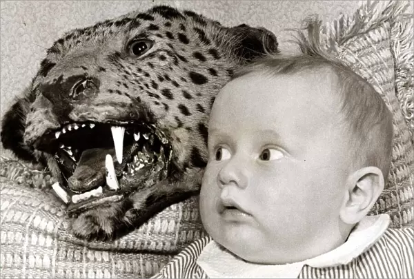 a Baby looks in shock at the scary leopard behind her - it doesn t matter that it