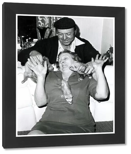 Eric and Queenie Robinson play with their pet Ferret s