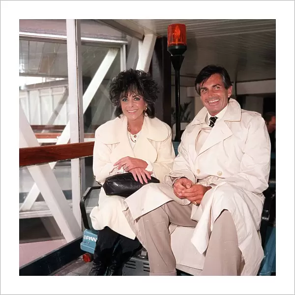 Liz Taylor actress and George Hamilton actor at London airport, August 1986