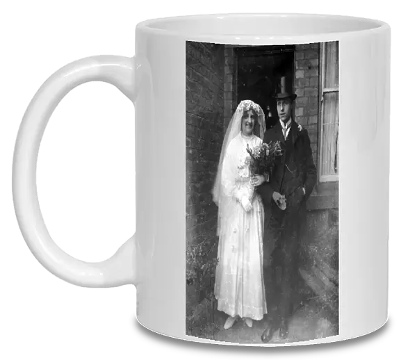 An old time wedding circa 1925 A bride and groom pose outside their North East home