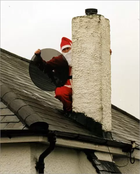 Christmas - Satellite and tv aerial installer Matthew Bloom dressed as Father Christmas