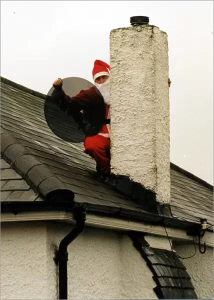 Christmas - Satellite and tv aerial installer Matthew Bloom dressed as Father Christmas