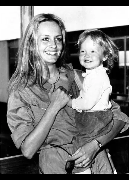 Twiggy Model and Actress holding baby