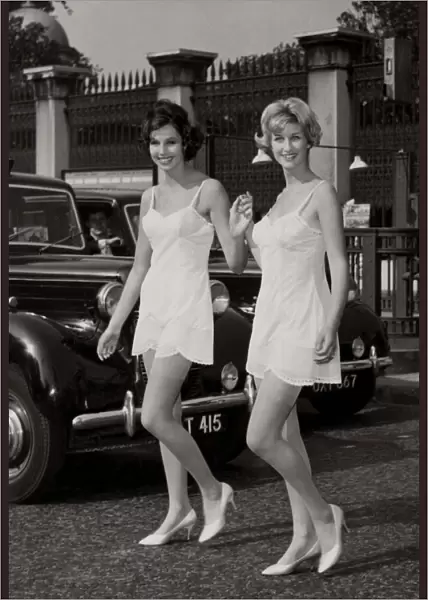 Two models walking by Hyde park corner wearing their slips after slipping out from a