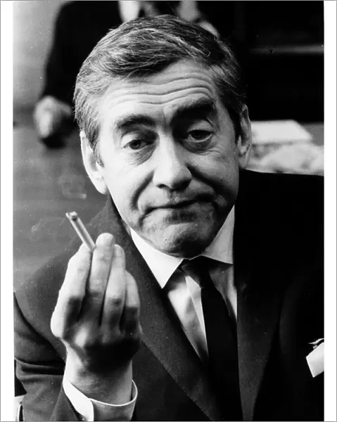 Tony Hancock holding up a lit cigarette August 1966