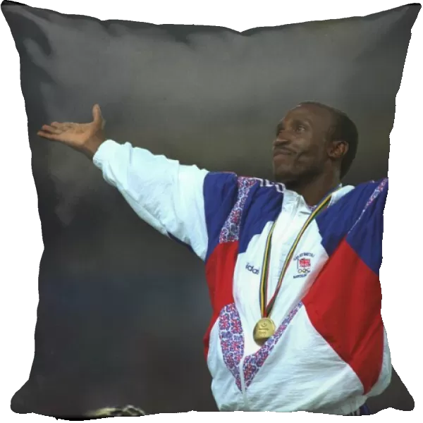 Linford Christie of Great Britain acknowledges the cheers of the crowd during the medal