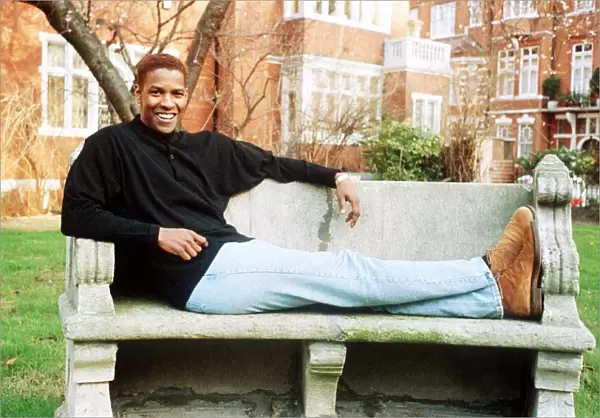 Denzel Washington Actor sitting on a bench
