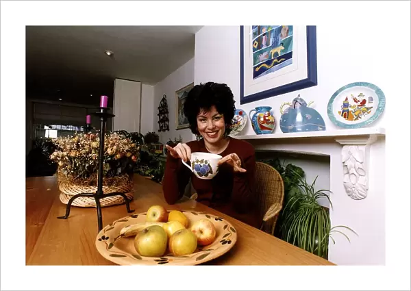Ruby Wax TV Presenter sitting in her kitchen with a mug in her hand in Woodstock