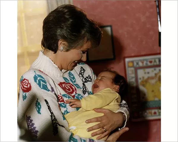 Anne Diamond cuddles tiny Clemency one of the babies used in the ad