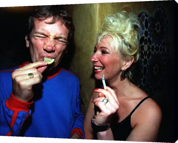 Frank Skinner eats a lemon watched by comedian Jenny Eclair at at Edinburgh Festival