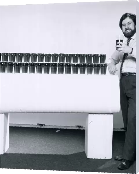 Journalist Alister Martin stands beside counter with 33 pints of beer