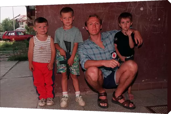 Jerome Flynn actor with children in Bosnia travelling with Red Cross
