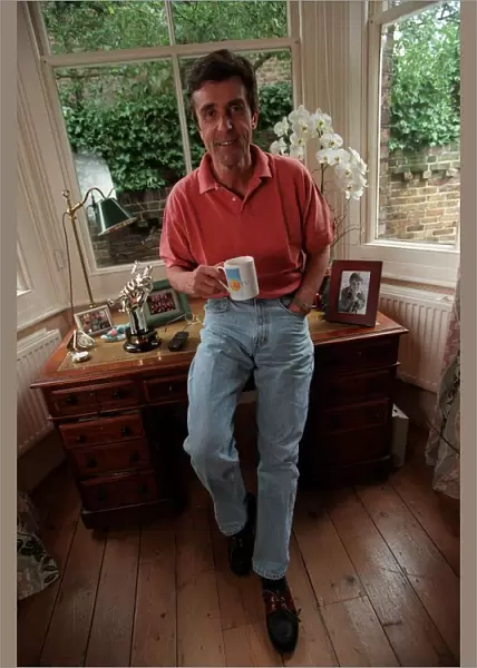 John Stapleton TV Presenter September 1998 At home sitting on his desk