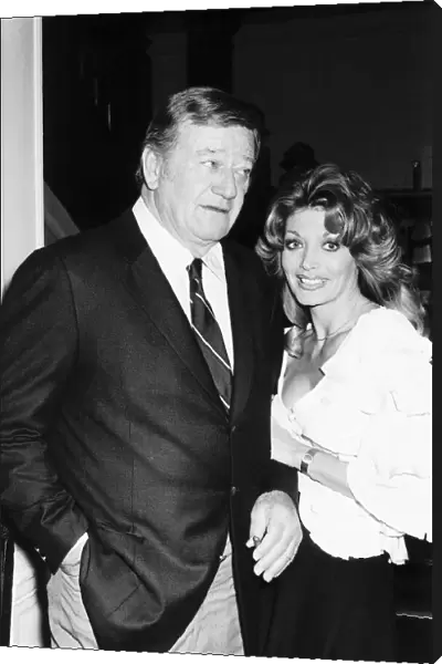 John Wayne with Miss Toni Holt who asked him to do a nude pin-up for her magazine