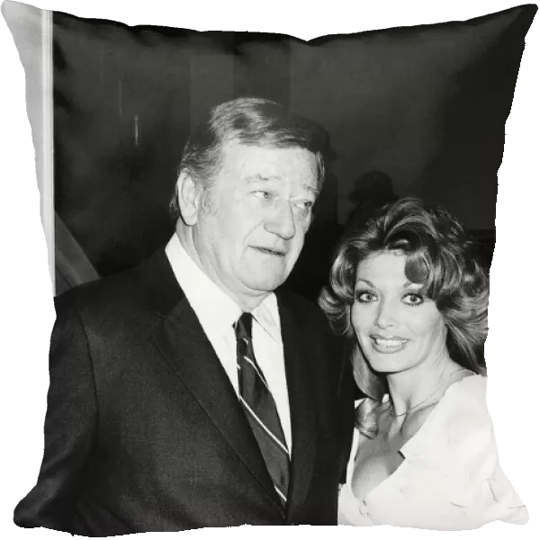 John Wayne with Miss Toni Holt who asked him to do a nude pin-up for her magazine