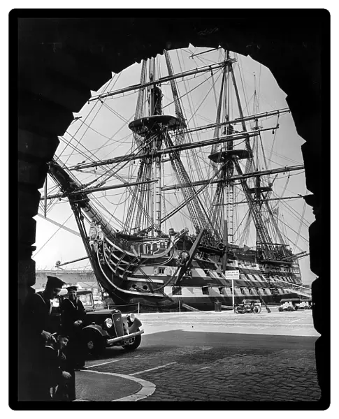 HMS Victory the flagship of the fleet framed in an arch in Portsmouth dockyard