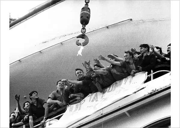 Soldiers aboard the QE2 reaching out for a bra that is up for grabs belonging to a Lance