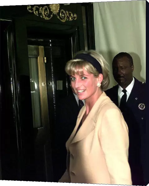 Diana, Princess of Wales, wearing sand coloured suit with black top and matching headband