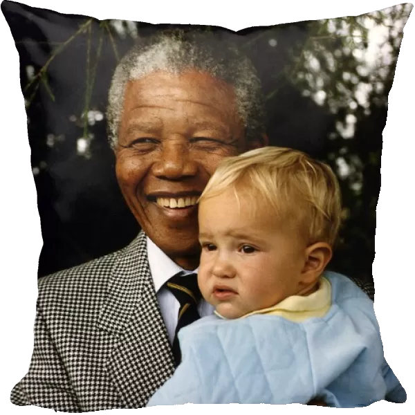 South Africas President Nelson Mandela with a young white boy