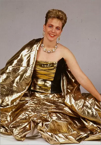Hazel Irvine TV presenter September 1988 wearing gold evenign sress sitting on floor
