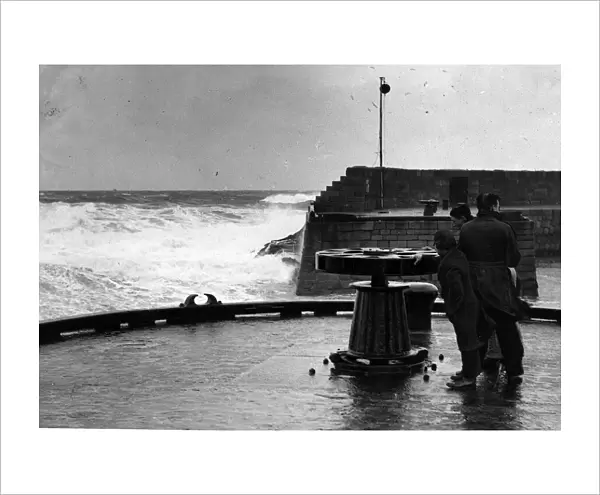 Storm waves crashing against the entrance to Peterhead Harbour in Scotland March
