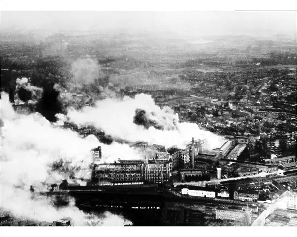 Smoke pours from The Philips radio valve works in Eidhoven Holland after a daylight raid