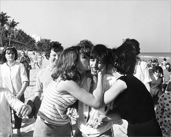 Ringo Starr is mobbed and kissed by fans in Miami during the Beatles tour of the USA