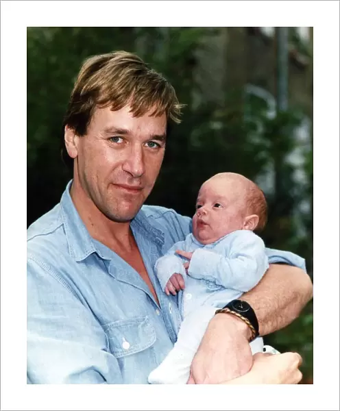 Tim Bentinck with his four months old son Jasper at home in the garden September
