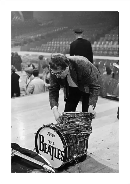 Mal Evans dismantles Ringo Starrs drum kit after the concert in Washington DC during