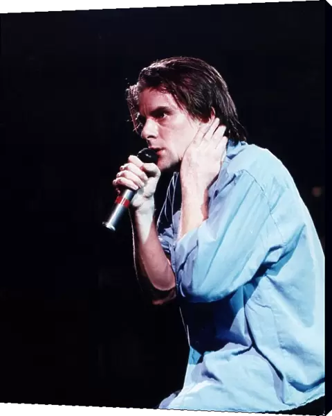 Ricky Ross singer rock band pop group Deacon Blue on stage holding microphone May