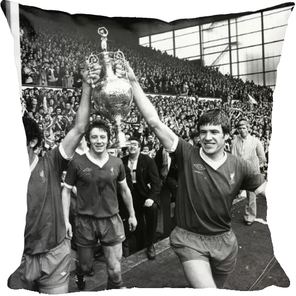 Liverpool players Ray Kennedy (L) and Emlyn Hughes celebrate with the League Championship