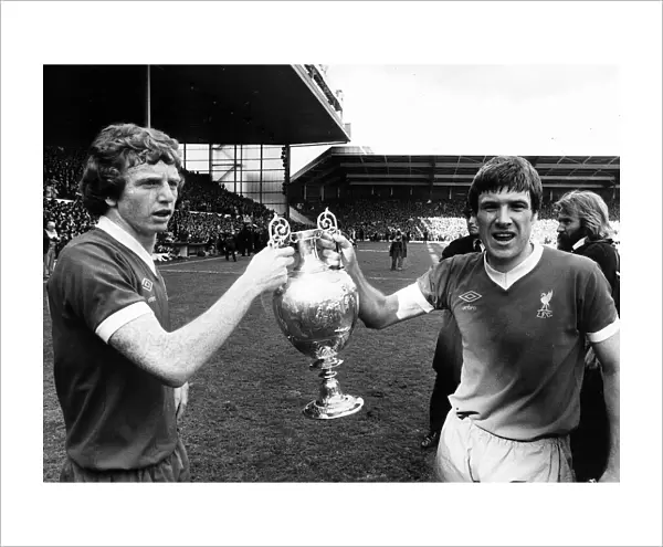 Liverpool captain Emlyn Hughes and David Fairclough celebrate with the League