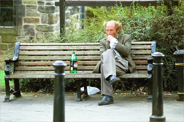 A Newcastle tramp drinking on a bench