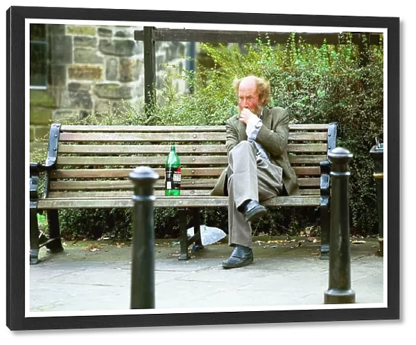 A Newcastle tramp drinking on a bench