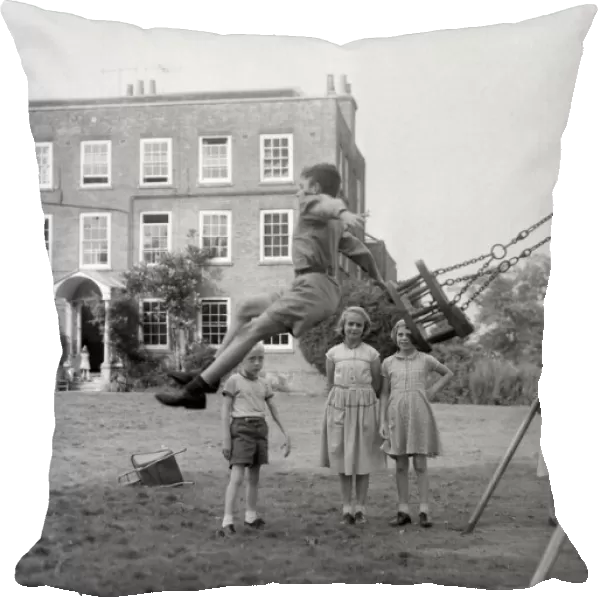 Children playing on the swings at Beech Hill House convalescent home in Berkshire