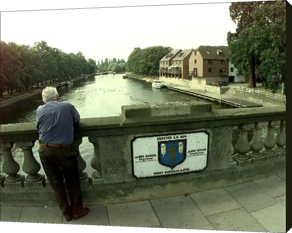 A view from the Workman Bridge in Evesham. Man standing on a bridge over the River Avon