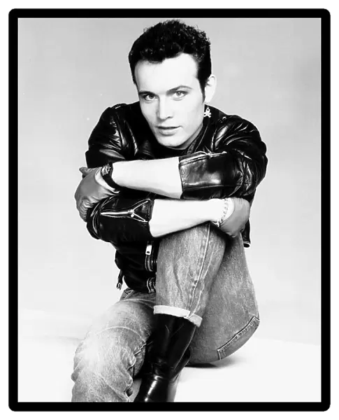 Adam Ant pop singer arms round leg jeans leather jacket Circa 1980