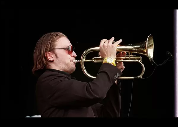 Member of the Fun Loving Criminals on stage playing the trumpet at T in the Park July