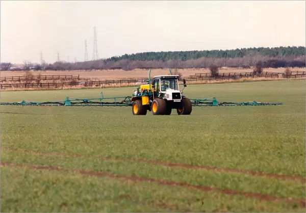 A farmer spraying his field with insecticide