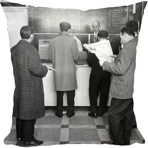 A queue of punters waiting to place bets in the shop before a race March 1963
