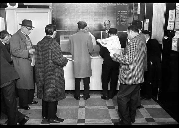 A queue of punters waiting to place bets in the shop before a race March 1963