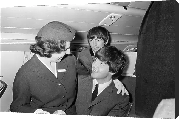 Paul McCartney has an air stewardess sitting on his knees on board the plane bound for