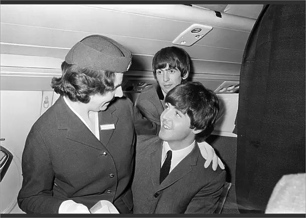 Paul McCartney has an air stewardess sitting on his knees on board the plane bound for