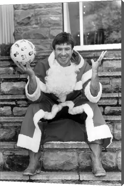 Soccer star Emlyn Hughes pictured as Santa Claus at his home in Sheffield
