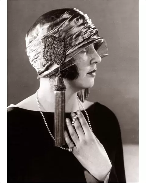 Hat fashion - April 1924 Woman wearing elaborate hat with tassles