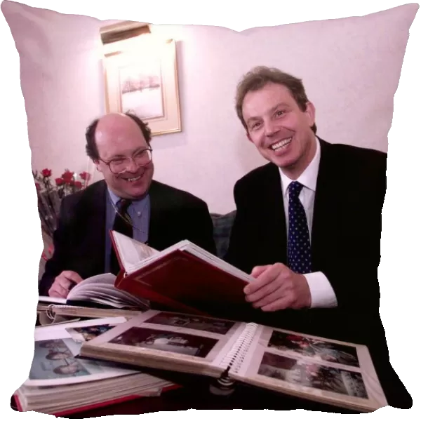 Tony Blair looking through family photograph albums
